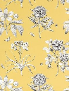 a yellow wallpaper with white flowers on it