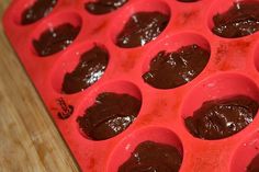 chocolate cupcakes are lined up and ready to go in the oven for baking