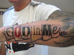 a man is holding his arm with the word god in me written on it,