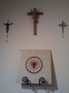 three crosses mounted to the side of a wall