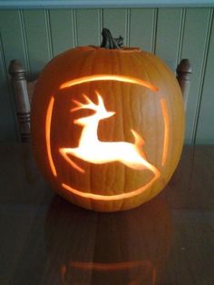 a carved pumpkin with a deer on it