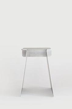 a small white table sitting on top of a white floor