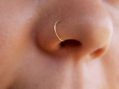 a close up view of a nose with a ring on it