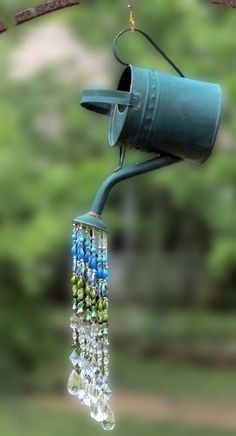 a bird feeder hanging from a tree branch with the words go get more on it