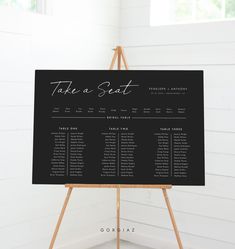 a black and white wedding seating chart on an easel