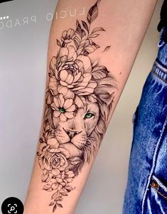 a woman's arm with a lion and flowers on it