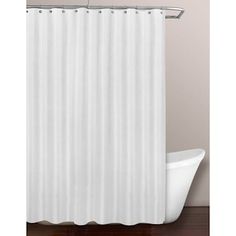 a white shower curtain hanging on the side of a bath tub