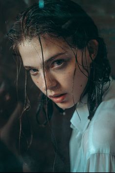 a woman with wet hair is looking at the camera