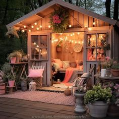 a small wooden house with lots of lights on the roof and plants in pots outside