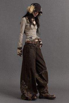 These vintage-inspired, wide-leg pants have a faux layered design and relaxed fit. They feature cross embroidery on one leg and an artistic script print on the other. The high-waist and wide-leg silhouette offer both comfort and style.  Wide-leg,... Romantic Punk Fashion, Weird Clothes, No Romance, Cross Embroidery, Hippie Style Clothing, Weird Fashion, Y2k Clothing, Layered Design, Lookbook Outfits