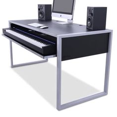 a computer desk with a keyboard, monitor and speakers sitting on it's sides