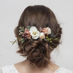 a woman with flowers in her hair is wearing a flower headpiece on her wedding day