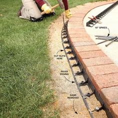 a man laying bricks on the ground with tools in his hand and instructions to install them