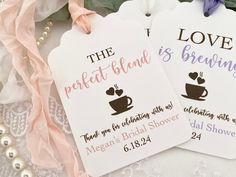 two tags with the words love, perfect blends, and coffee are on a lace tablecloth