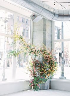 a vase filled with flowers sitting on top of a window sill