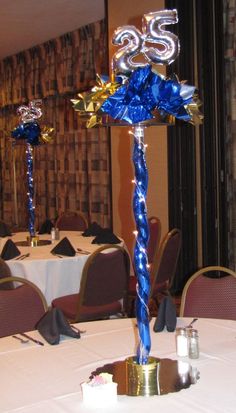 a blue and white centerpiece on top of a table in a room with chairs