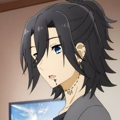 an anime character with black hair and blue eyes staring at the camera, in front of a television screen