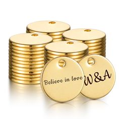 a stack of gold tags with the words believe in love and w & a on them