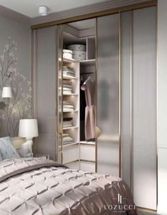 a white and gold bedroom with mirrored closets in the wall, bedding and lamps on either side