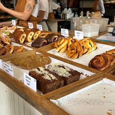 many different types of pastries on display at a bakery