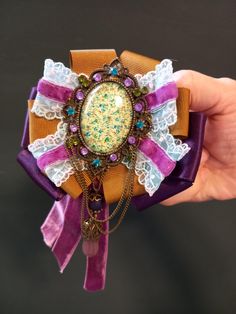 These Victorian style medal brooch adorned with purple and brown velvet ribbon, lace, colorful glass crystal on the cabochon frame and teardrop is gorgeous for any  special occasion as well as Baroque/Goth style lovers. The color of the images may vary slightly due on the monitor settings If you would like to customize this or another design special to your , or if you have any other questions, please contact me, I will be happy to help! Thank you very much for visiting my shop! Ribbon Brooch, Purple And Brown, Style Baroque, Goth Style, Purple Ribbon, Brown Velvet, Velvet Ribbon, Glass Crystal, Victorian Style