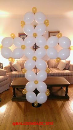 white and gold balloons in the shape of a snowflake on a coffee table