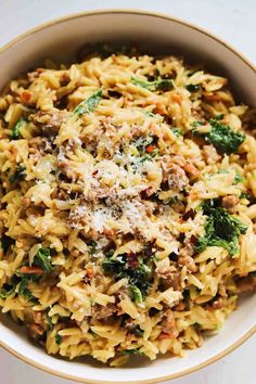 a white bowl filled with pasta and meat