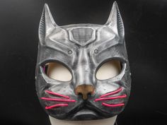 Ready to go wild at the next dance party, festival, rave or just a regular Monday evening photo shoot? Meet Cyborg Cat! This mask is a personal favorite of ours to wear to parties because the electroluminescent whiskers are instant eye-catchers, with three settings for blinking or a steady light and you can choose from pink (pictured here), red, blue, green or white for your very own custom made mask.  Cyborg Cat is made with PLA and hand painted and comes with an adjustable leather strap built Evening Photo, Monday Evening, Costume Masks, Cat Mask, Moustaches, Costume Mask, Go Wild, Party Festival, Dance Party