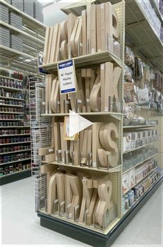 there are many wooden letters on the shelves in this store, and it is time to cut them out