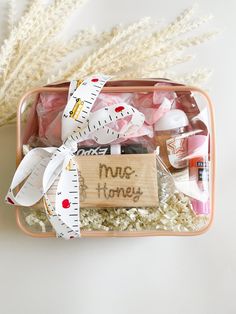 a pink container filled with lots of crafting supplies