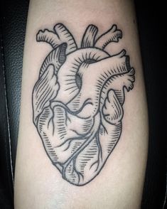 a black and white heart tattoo on the leg