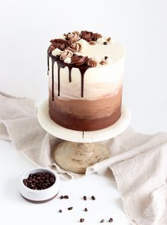 a cake sitting on top of a white plate next to a bowl of chocolate chips