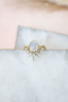 "R A I N B O W   M O O N S T O N E   R I N G   S E T Want to stack? We got you! The Aurora ring set is the perfect duo, and we've done the work for you! Stacked and ready to go, this set is absolutely stunning. With its faceted cut dainty rainbow moonstone gems creating a halo around a shimmery oval stone, you truly can't go wrong with this statement piece.  This set will come with TWO separate rings! The oval ring, and the multi stone halo ring.  *Material : 14k gold vermeil over 925 Sterling S Gold Moonstone Ring, Moonstone Stone, Rainbow Moonstone Ring, Gold Ring Sets, Oval Rings, Moonstone Ring, Multi Stone, Stackable Rings, Rainbow Moonstone