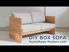 a wooden box sofa sitting on top of a white floor