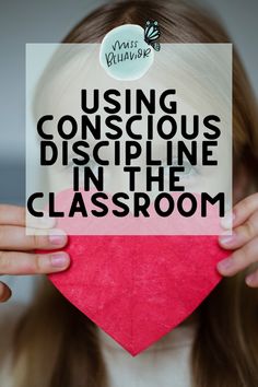 a girl holding up a sign with the words using conscious discipline in the classroom on it