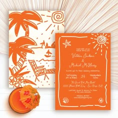 an orange and white beach themed wedding suite with umbrella, fan, and sunburst