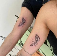 two people with matching tattoos on their arms