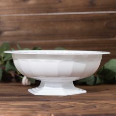 a white bowl sitting on top of a wooden table