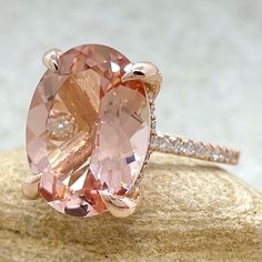 This Large Oval Morganite Ring is part of our Olivia Collection, which is characterized by a gorgeous, genuine gemstone held by 4 diamond encrusted prongs. Diamonds stud the hidden halo and sparkle down the half eternity shank.  Golden Hearts under the Center Stone, and custom initials at the back of the shank are available on all rings upon request!

Center Stone: Genuine AAA Peachy Pink Morganite, Oval Cut, averaging 16x12mm and 8.25 carats.
Side Stones: 78 Diamonds – you choose Lab Grown or O Oval Morganite Ring, Ring Hidden Halo, Golden Heart, Ring With Diamond, Pink Morganite, Morganite Ring, Hidden Halo, Custom Initials, Unique Engagement