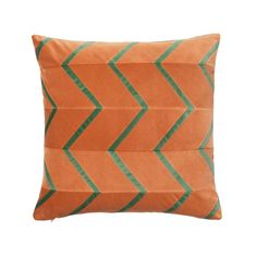 an orange pillow with green stripes on the front and back, against a white background