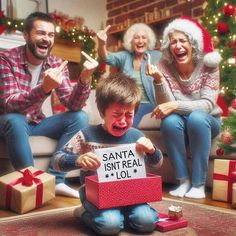 a group of people sitting around a christmas tree with presents in front of them and the man holding a sign that says santa isn't real lol