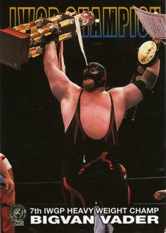 a wrestler holding up his trophy in front of other wrestlers on the cover of a magazine