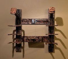 a wooden shelf with two shelves on each side and the words nf painted on it