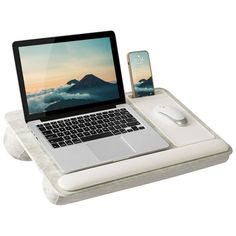 an open laptop computer sitting on top of a white tray next to a mouse and cell phone