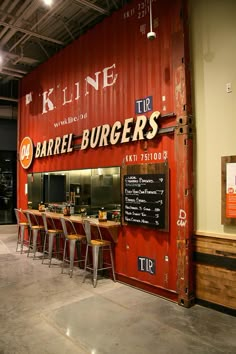 the interior of a restaurant with red shipping containers