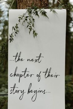 a sign hanging from the side of a tree that says, the next charter of their story begins