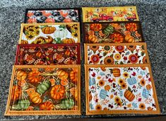 four square plates with pumpkins and sunflowers on them