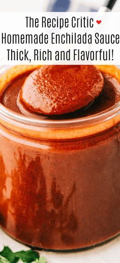 a jar filled with homemade enchilada sauce on top of a white table