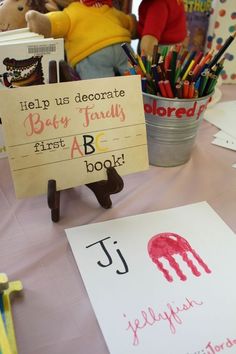 a child's handprinted sign sitting on top of a table next to books