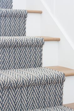 the carpet on the stairs is blue and white